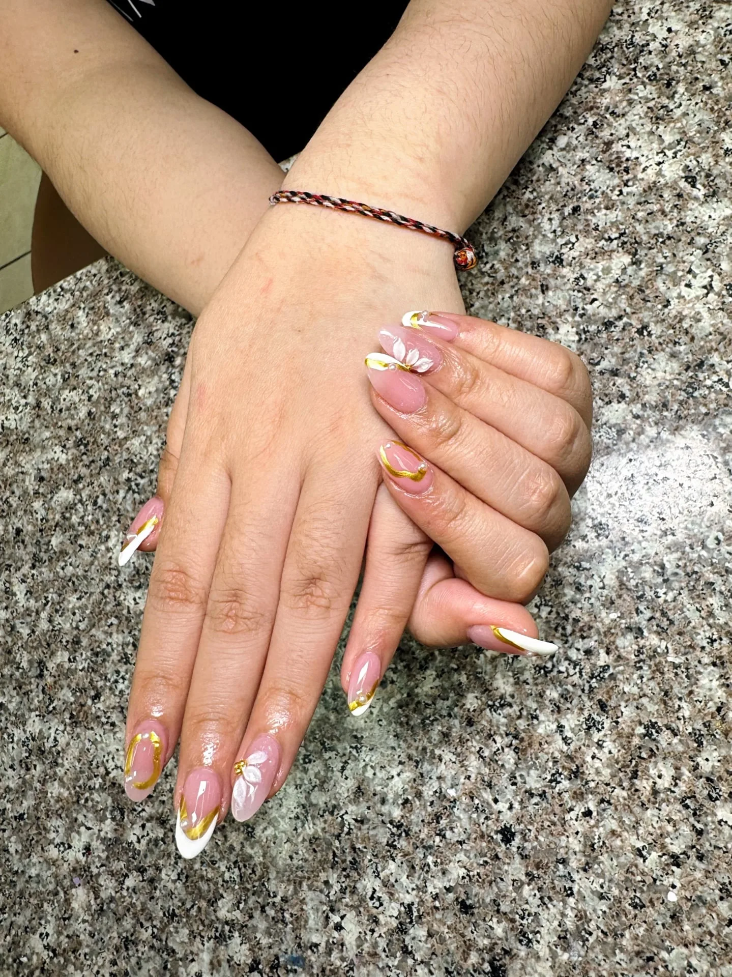 White and gold floral nail art created at Perfect Nails in Saint Paul