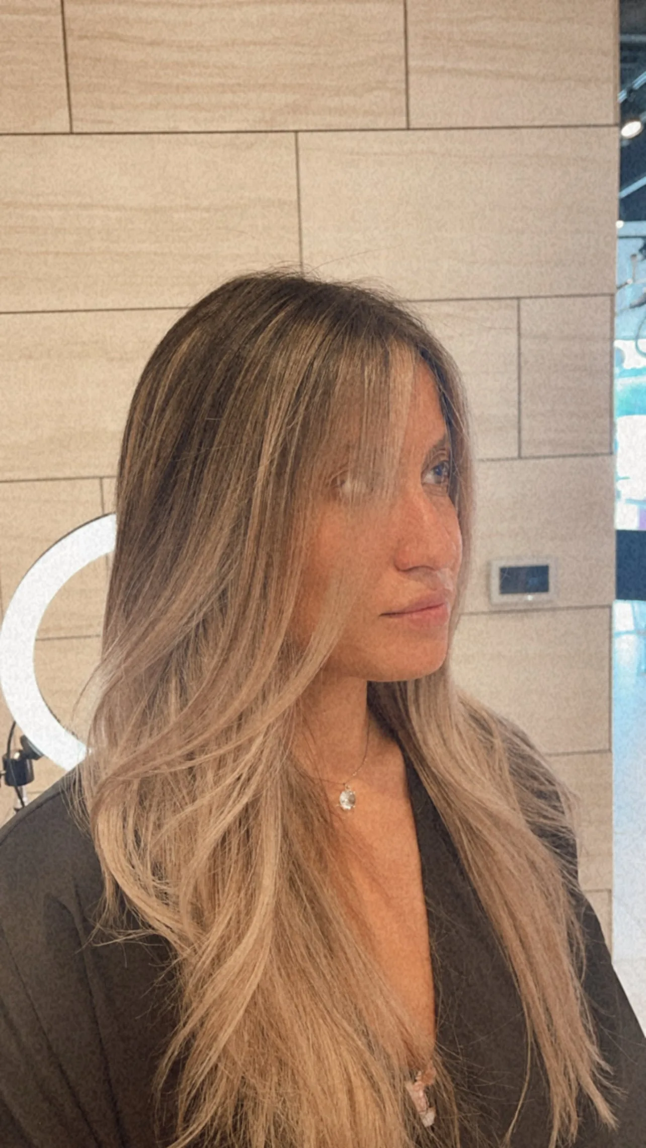 Client seeing finished bleach and tone result in mirror