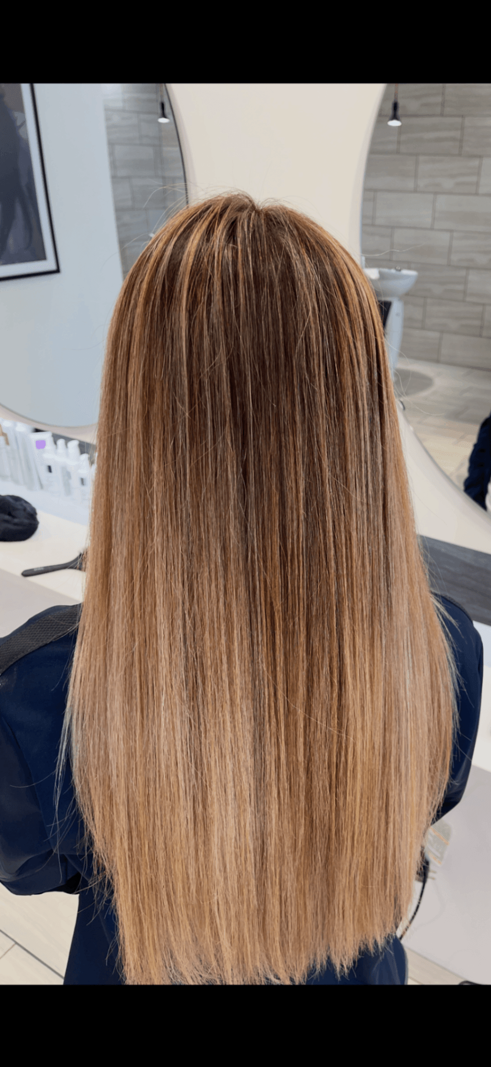 Client and stylist at Salon Sanaa choosing a color shade together